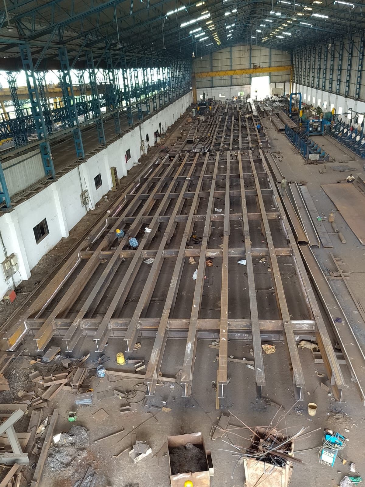 Fabrication bay with girders laid out for assembly