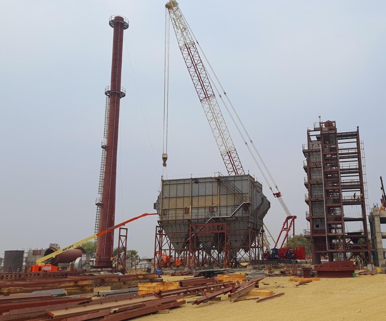 Plant erection in progress with chimney and hopper structures
