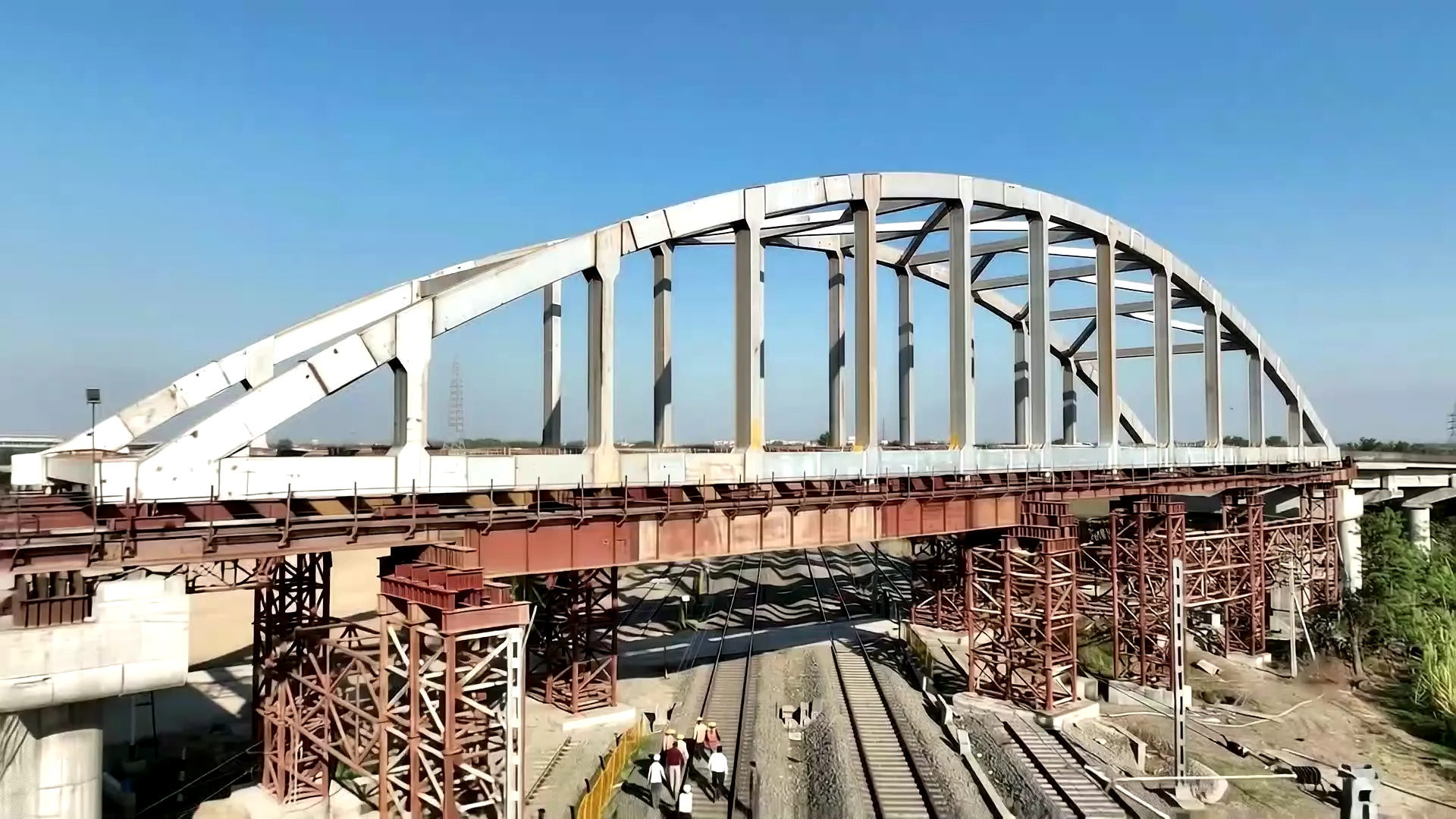 Bow string girder being lifted onto a road over bridge