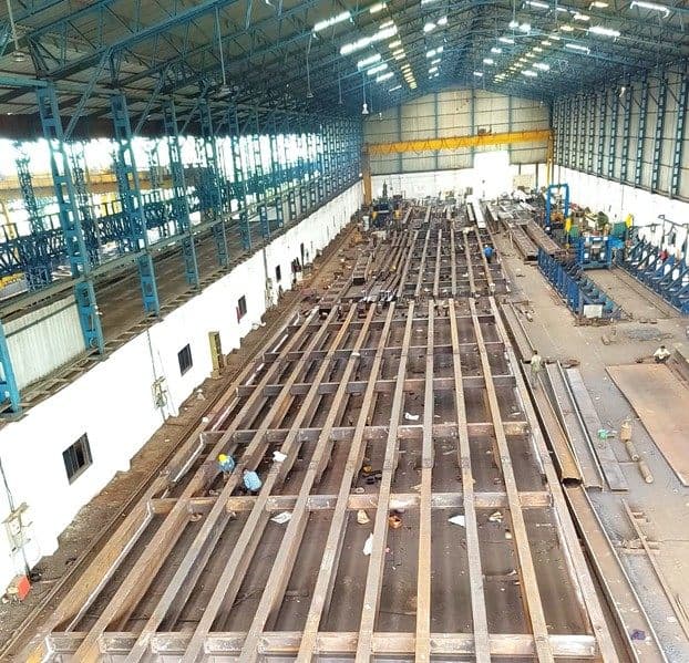 Assembly area with girders laid out across the bay