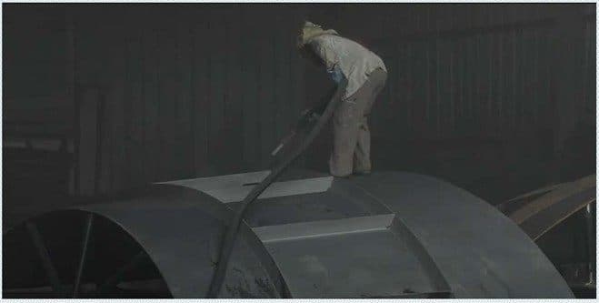 Blasting shop, surface preparation of a fabricated shell